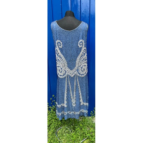 851 - A 1920’s beaded evening dress embellished with blue, silver, white and clear beads.