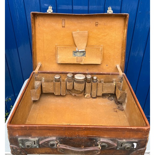 1316 - A vintage leather suitcase initialed R.W, together with 5 silver lidded glass jars. Birmingham 1912.... 