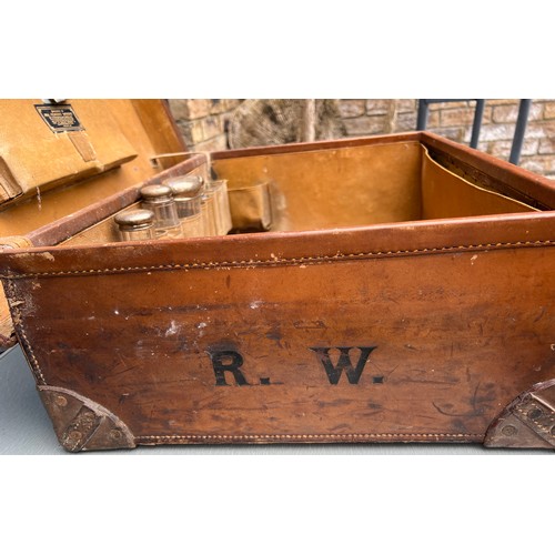 1316 - A vintage leather suitcase initialed R.W, together with 5 silver lidded glass jars. Birmingham 1912.... 