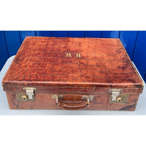 1317 - A vintage crocodile leather suitcase initialed R.W with brass fittings. Suitcase measures 56cm wide ... 