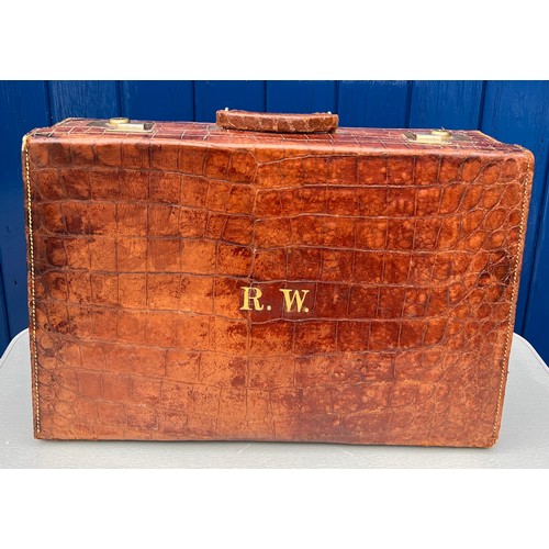 1317 - A vintage crocodile leather suitcase initialed R.W with brass fittings. Suitcase measures 56cm wide ... 