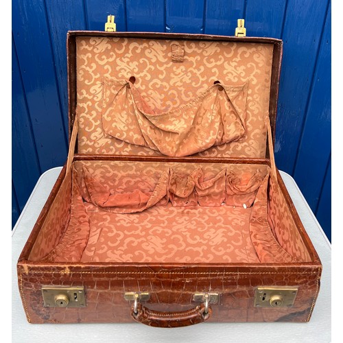 1317 - A vintage crocodile leather suitcase initialed R.W with brass fittings. Suitcase measures 56cm wide ... 