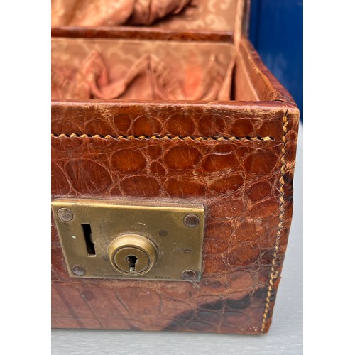 1317 - A vintage crocodile leather suitcase initialed R.W with brass fittings. Suitcase measures 56cm wide ... 