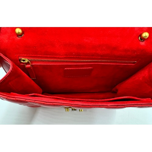 880 - A Christian Dior Cannage 'Dior Addict' leather bag in red. Gold chain and gold fittings. Suede inter... 