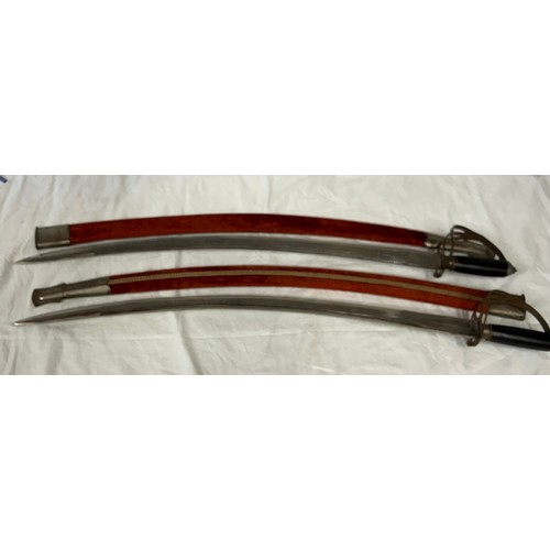 922 - Two Indian dress swords marked Golden Temple made in India, in velvet sheaths both measuring 97cm.