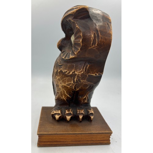 1006 - A German carved owl mantel clock, the owl seated on a book, having movement in his eyes. Stamped Ger... 