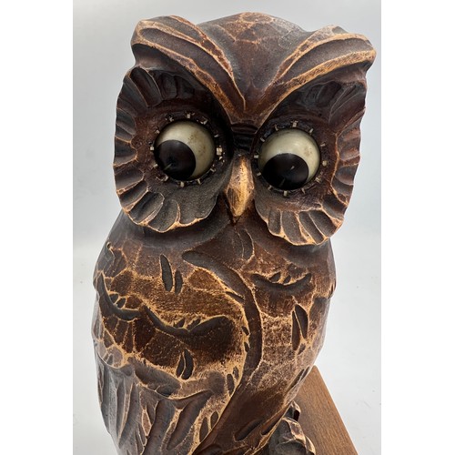 1006 - A German carved owl mantel clock, the owl seated on a book, having movement in his eyes. Stamped Ger... 