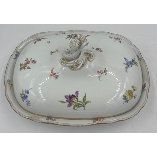 162 - A 19thC Dresden lidded tureen with hand painted sprigs of flowers. 30cm x 22cm approximately.