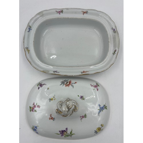 162 - A 19thC Dresden lidded tureen with hand painted sprigs of flowers. 30cm x 22cm approximately.