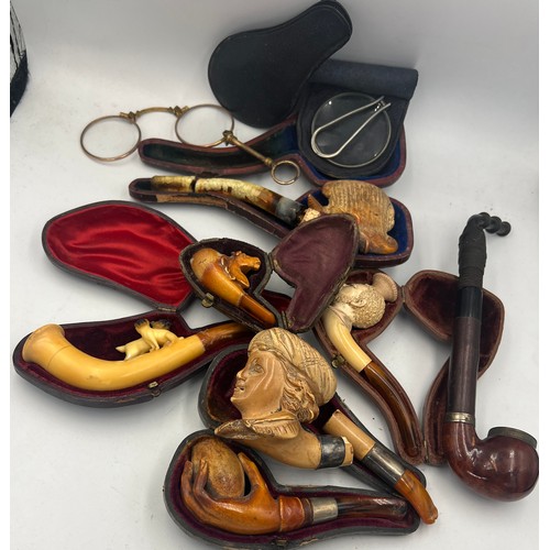 1323 - A quantity of carved Meerschaum pipes, lorgnette and a magnifying glass.