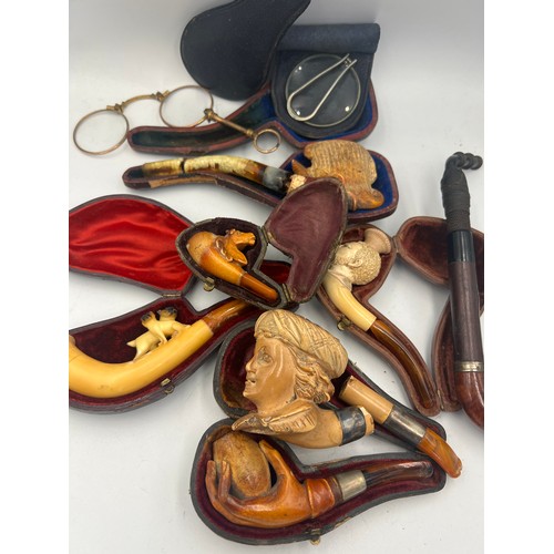 1323 - A quantity of carved Meerschaum pipes, lorgnette and a magnifying glass.