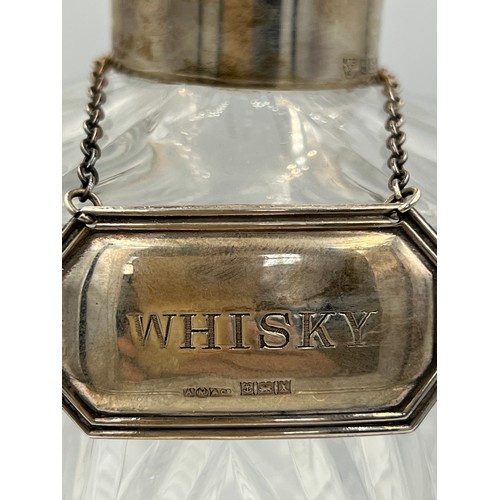 431 - A cut glass whisky decanter with silver collar and Whisky label Birmingham 1972.