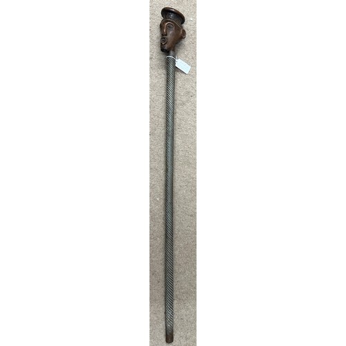 921 - An African stick with carved head and metal covered shaft, circa 1940’s, brought back to England dur... 