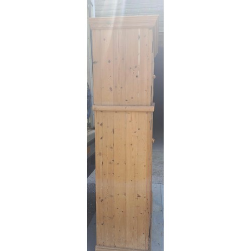 50 - Two pine cupboards, two glazed doors to top over two solid doors to base, with labels for John Smith... 