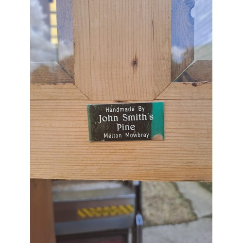 50 - Two pine cupboards, two glazed doors to top over two solid doors to base, with labels for John Smith... 