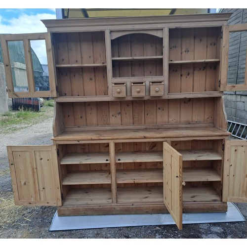 52 - A pine dresser with glazed cupboards and shelves to top and three cupboards to base with internal dr... 