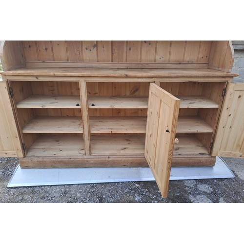 52 - A pine dresser with glazed cupboards and shelves to top and three cupboards to base with internal dr... 