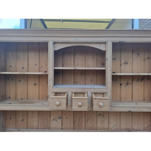 52 - A pine dresser with glazed cupboards and shelves to top and three cupboards to base with internal dr... 