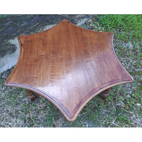 54 - A star shaped hardwood table. 48cm h x 118cm x 90cm.