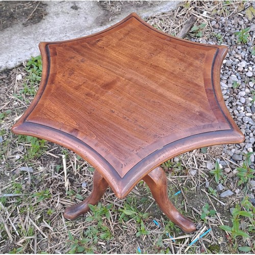 56 - A star shaped hardwood table 53cm h x 52cm x 52cm.