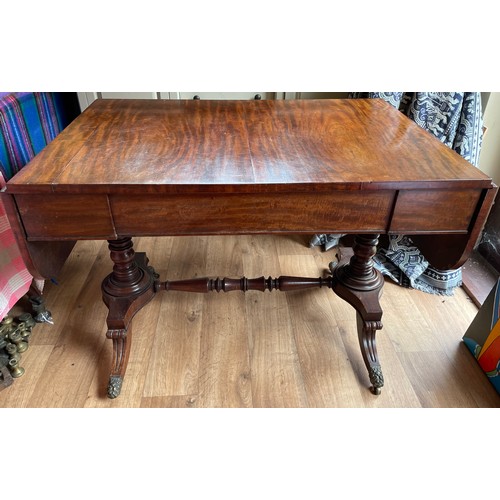 43 - A William IV figured mahogany sofa table on turned stretcher base terminating in reeded sabre legs w... 