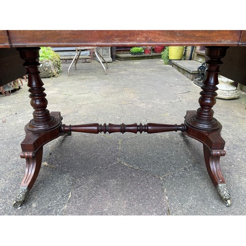 43 - A William IV figured mahogany sofa table on turned stretcher base terminating in reeded sabre legs w... 