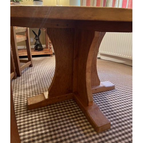 140 - A circular oak dining table with adzed top 128cm d x 73.5cm h together with four lattice backed dini... 