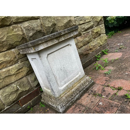 26 - A reconstituted stone plinth. Approximately 66cm h. Top 50cm w.