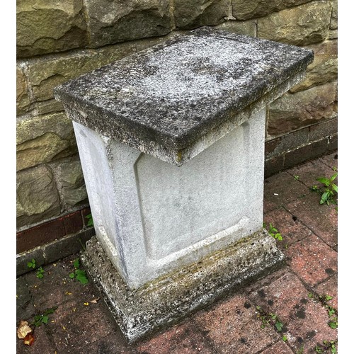 26 - A reconstituted stone plinth. Approximately 66cm h. Top 50cm w.