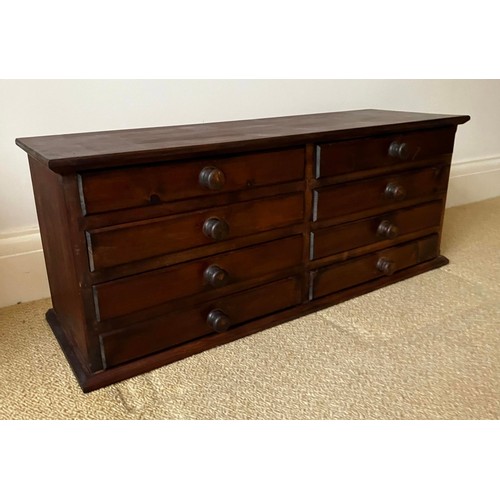 47 - A stained pine chest of eight drawers. Approximately 35cm h x 28cm d x 94cm w.