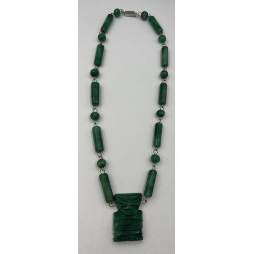 601 - A jade and silver 1960’s necklace from Mexico with a 4cm x 2cm ‘chipcha’ motif centrepiece. 50 cm l.