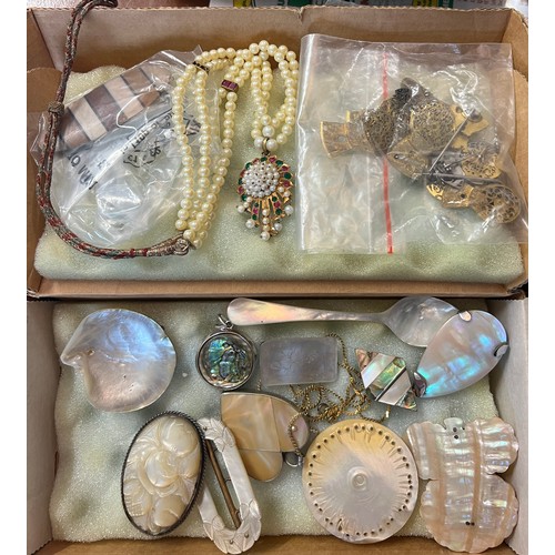 571 - A quantity of late 19th and early 20thC jewellery to include  beads, brooches etc.