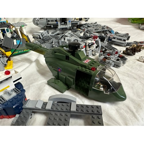 1211 - Lego, an unboxed quantity of loose items to include Star Wars Millennium Falcon, boat, helicopter, j... 