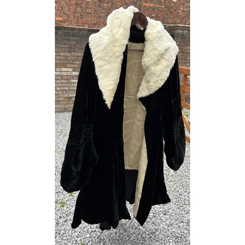 836 - A 1920’s black fur evening coat with white fur collar, cream silk lining and rouged sleeves.