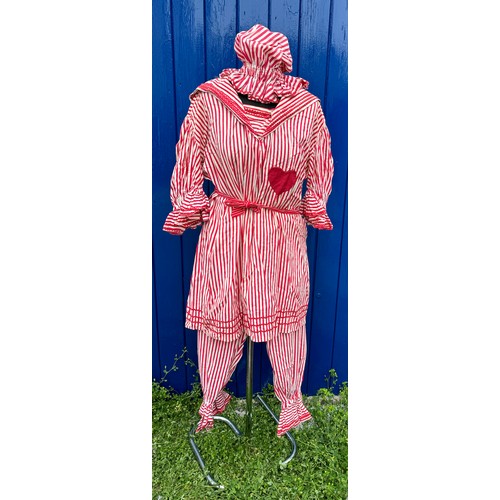 844 - An early 20thC red and white striped bathing costume comprising of top, bloomers, bonnet and belt.