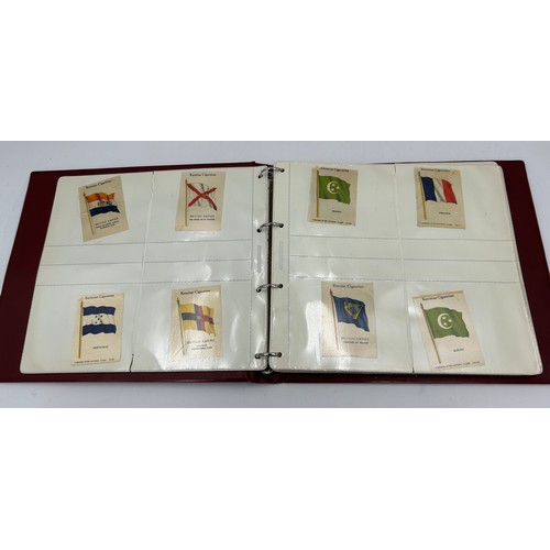 919 - An album containing 132 cigarette silks to include 29 x Kensitas, plus BDV etc. - Heraldic, Colonial... 