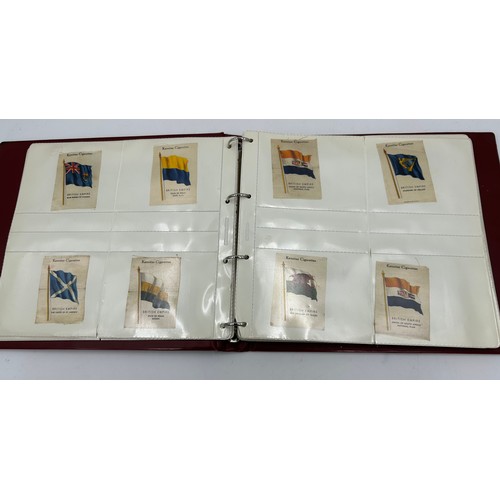 919 - An album containing 132 cigarette silks to include 29 x Kensitas, plus BDV etc. - Heraldic, Colonial... 