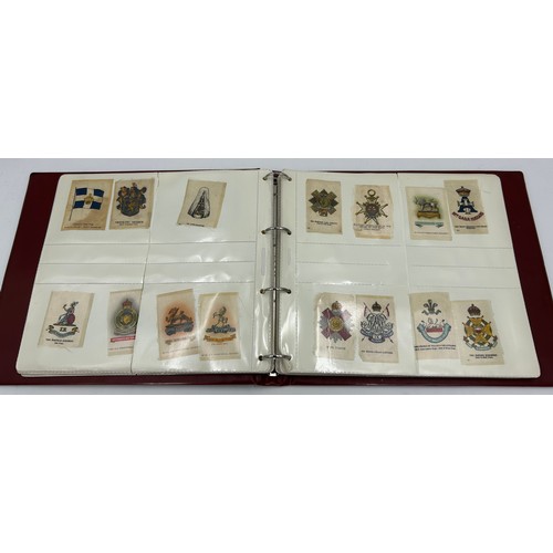 919 - An album containing 132 cigarette silks to include 29 x Kensitas, plus BDV etc. - Heraldic, Colonial... 