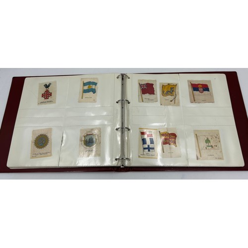 919 - An album containing 132 cigarette silks to include 29 x Kensitas, plus BDV etc. - Heraldic, Colonial... 