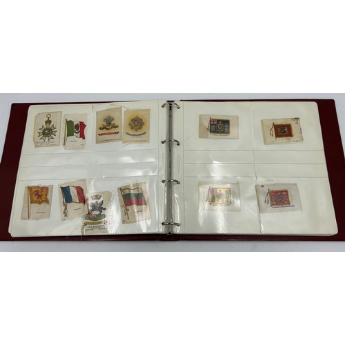 919 - An album containing 132 cigarette silks to include 29 x Kensitas, plus BDV etc. - Heraldic, Colonial... 