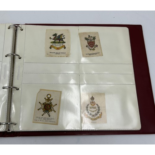 919 - An album containing 132 cigarette silks to include 29 x Kensitas, plus BDV etc. - Heraldic, Colonial... 