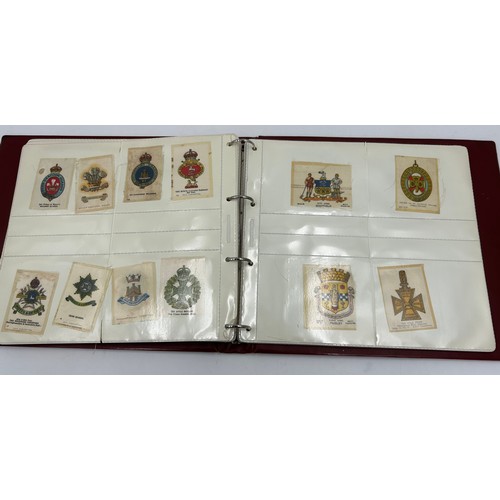 919 - An album containing 132 cigarette silks to include 29 x Kensitas, plus BDV etc. - Heraldic, Colonial... 