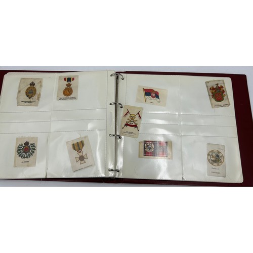 919 - An album containing 132 cigarette silks to include 29 x Kensitas, plus BDV etc. - Heraldic, Colonial... 