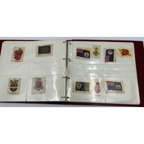 919 - An album containing 132 cigarette silks to include 29 x Kensitas, plus BDV etc. - Heraldic, Colonial... 