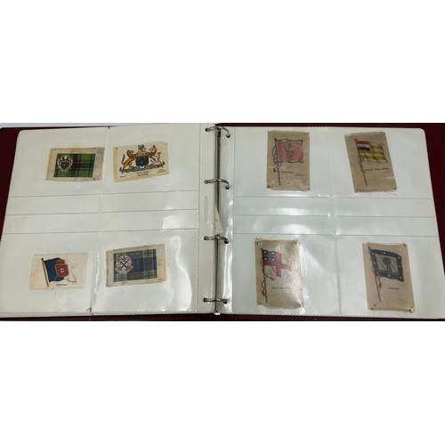 919 - An album containing 132 cigarette silks to include 29 x Kensitas, plus BDV etc. - Heraldic, Colonial... 