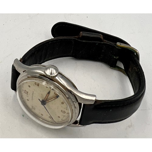 729 - A gentleman’s vintage Longines wristwatch on a black leather strap.