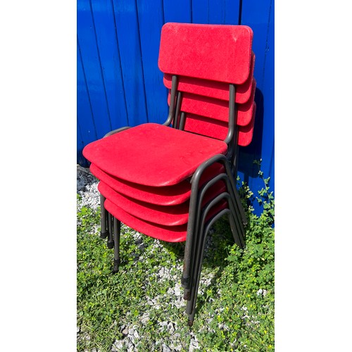 22 - A set of four Remploy children’s chairs in red plastic on tubular steel frames. Bearing original Rem... 