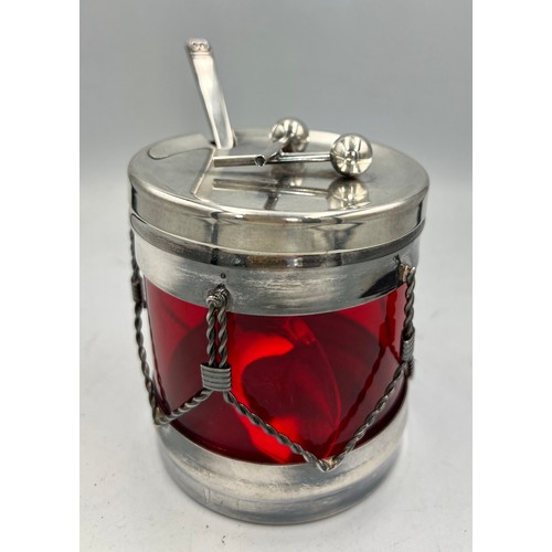 24 - A Viners International ruby glass lined preserve jar in the form of a drum with silver plated frame ... 