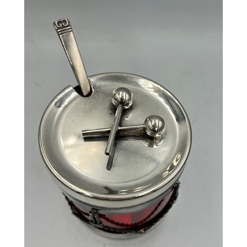 24 - A Viners International ruby glass lined preserve jar in the form of a drum with silver plated frame ... 