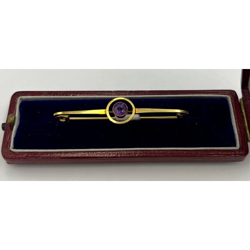 84 - An 9 carat gold Art Deco target brooch set with a circular amethyst in a red leather silk lined pres... 